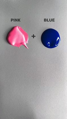 two blue and one pink buttons on a silver surface with the same button highlighted in red