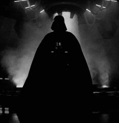 darth vader silhouetted in front of stage lights