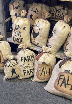 several bags with words on them sitting in front of a shelf filled with other bags