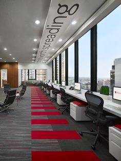 an office with red carpet and large windows