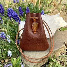 a brown purse sitting on top of a rock