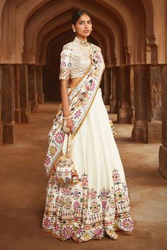 Ivory silk lehenga with floral motifs highlighted in sequin and mirror work. Paired with blouse and silk dupatta in zari, gota, sequins, resham and mirror work.
Component: 3
Pattern: Embroidered
Type Of Work: Zari, Gota, Sequins, Resham and Mirror
Neckline: Round
Sleeve Type: Short Sleeves
Fabric: Silk
Color: White
Other Details: 
Floral motifs
Back tassel tie-up
Note: Neckpieces and potli bag shown in the image is not for sale
Occasion: Sangeet, Destination Wedding - Aza Fashions Mayyur Girotra, Unique Bridesmaid Dresses, Unique Bridesmaid, Indian Dress, Silk Lehenga, Chaniya Choli, Silk Dupatta, Designer Gowns, White Silk