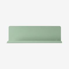 a light green shelf sitting on top of a white wall