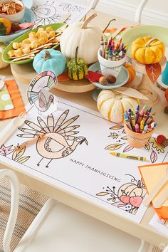 a table topped with lots of thanksgiving decorations