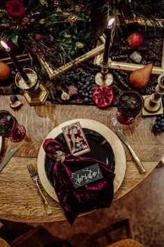 a wooden table topped with a plate covered in purple cloth next to a christmas tree