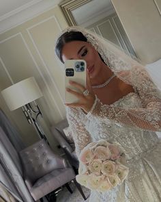 a bride taking a selfie in her wedding dress