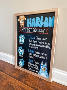 a chalkboard sign that says harlan my first birthday with pictures of dogs on it