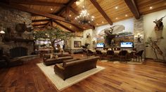 a large living room with wood floors and high ceilings