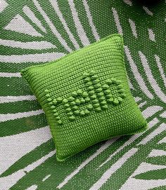 a green pillow sitting on top of a table