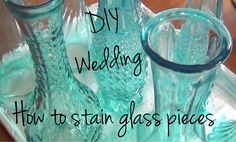 some glass vases are on a tray with the words diy wedding how to stain glass pieces