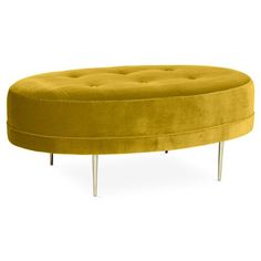 a round yellow ottoman with metal legs