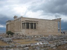 the ruins of an ancient city with birds sitting on it's stone flooring