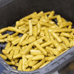 yellow pasta noodles are in a gray container