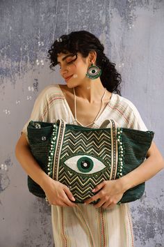 Keeping up with the trendiest color of the season, say hello to your favourite Evil Eye Embellished Tote, now here in an Evergreen Forest color. A show-stopping glory for when all eyes must be on you. This tote bag is perfect for everyday use and for special occasions too! It features a hand beaded evil eye in front for protection, and is hand-embellished with beads and sequins for a touch of glamour. The double shoulder straps are adorned with lace detail, and the bag has a magnetic button clos Green Shoulder Bag For Summer Parties, Green Shoulder Bag For Shopping, Green Summer Party Shoulder Bag, Green Summer Party Bags, Green Large Capacity Party Bags, Green Embellished Rectangular Shoulder Bag, Embellished Green Rectangular Shoulder Bag, Chic Embellished Green Bags, Chic Green Embellished Bags