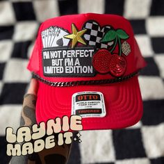 a red hat with the words i'm not perfect but i'm a limited edition on it