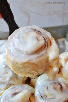 a close up of a cinnamon roll on a spoon