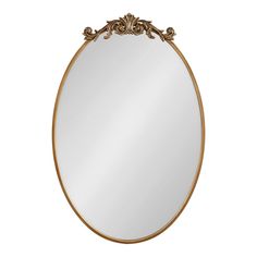 a round mirror with an ornate frame