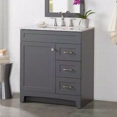 a bathroom vanity with two sinks and a mirror on the wall next to a towel rack