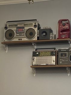 there are two shelves with radio and boomboxes on top of each shelf in the room