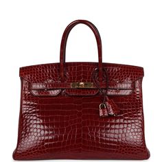 This Birkin is of Rouge H shiny Porosus Crocodile leather with gold hardware and features tonal stitching, front flap, two straps with center toggle closure, clochette with lock and two keys, and double rolled handles.The interior is lined with Rouge H chevre and has one zip pocket with an Hermes engraved zipper pull and an open pocket on the opposite side.Collection: M Square Origin: FranceCondition: Pre-owned; Excellent-The bag has some slouching on the sides and structure loss around the bottom of bag. There's partial plastic on the hardware. Visible scratches to the exposed hardware. The exterior leather shows has some minor wear with creasing and scratching to pull straps and wear around the bottom corners. The interior leather is clean with minor scuffs to interior leather base. The Red Birkin, Rose Bag, Hermes Birkin 35, Luxury Bags Collection, Hermes Birkin 25, Birkin 25, Bags Aesthetic, Madison Avenue, Crocodile Leather