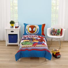 a bedroom with blue walls and wooden floors has a spiderman bedding set on it