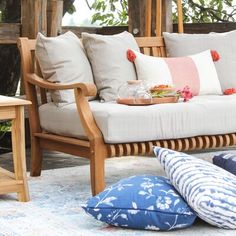 a couch and some pillows on a patio