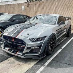 two cars parked next to each other in a parking lot