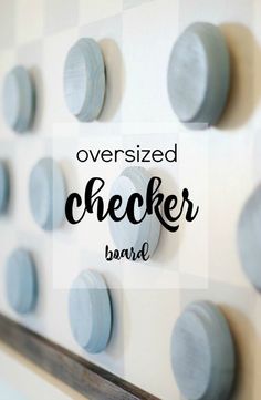 the words oversized checker board are displayed on a wall with blue knobs