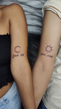 two people with matching tattoos on their arms