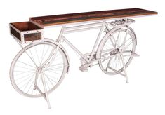 an old fashioned bicycle with a wooden shelf on it's back end and wheels attached to the seat