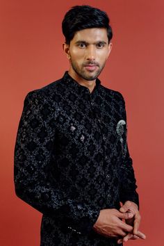 "Make an edgy statement with our BLACK SILVER EMBROIDERED INDO WESTERN designed thoughtfully for the modern Indian man. A fusion staple fit for every occasion, adds the right amount of cultural twist to the western silhouette. Color: Black  Garment Type: Indo Western Neck: Mandarin Collar Fabric: Micro Velvet Embroidery: Zari work with sequin embroidery The Product Price is inclusive of: 1 Indo-Western and 1 Trouser Style Bottom Model is 6'2\" wearing Size 38 Product color may slightly vary due to photographic lighting sources or your screen settings." Jodhpuri Sherwani For Men, Jodhpuri Sherwani, Western Silhouette, Indian Jackets, Sherwani For Men Wedding, Jodhpuri Suit, Velvet Embroidery, Sherwani For Men, Printed Velvet