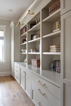 a white bookcase with lots of books on it