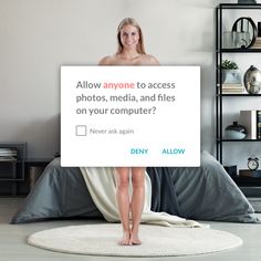 a woman holding up a sign that says allow anyone to access photos, media, and files on your computer?