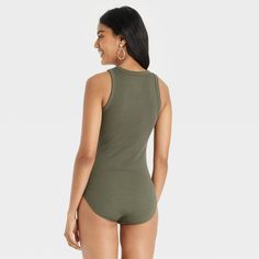 Update your separates closet with the Ribbed Crewneck Tank Bodysuit from A New Day™. This sleeveless bodysuit is designed with an allover ribbed pattern in an elegant solid hue for a chic and sophisticated look, and it has reinforced ribbed trim around the neck and armholes for additional flair. The pull-on tank bodysuit is made from a soft and stretchy fabric to give you a comfortable fit that moves with you, and it boasts a full-coverage bottom along with metal snaps at the crotch for added co Fitted Sleeveless Bodysuit For Daywear, Green Sleeveless Bodysuit For Loungewear, Green Sleeveless Cotton Bodysuit, Green Fitted Tank Top For Loungewear, Fitted Green Tank Top For Loungewear, Katy B, Basic Bodysuit, Tank Bodysuit, Long Torso