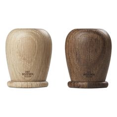 two wooden salt and pepper shakers sitting side by side