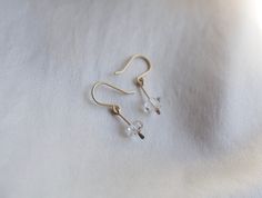 These dainty earrings are a cute way to add a little subtle sparkle to your look! Elegant and understated crystal earrings, but with a raw feel to them. The clean design of these earrings makes them really classy and versatile. Each earring contains a teeny floating Herkimer diamond. Herkimer diamonds are mined from a specific mine from New York State and are known by the double termination (pointy on both sides of the crystal) They are held in a little drop of brass, hammered for a rough textur Minimalist Crystal Earrings For Everyday, Minimalist Adjustable Crystal Earrings, Dainty Hypoallergenic Crystal Earrings For Everyday, Minimalist Dangle Crystal Earrings, Minimalist Crystal Drop Earrings, Minimalist Dangle Crystal Earrings With Ear Wire, Minimalist Crystal Drop Earrings With Ear Wire, Minimalist Sterling Silver Crystal Earrings For Everyday, Everyday Minimalist Sterling Silver Crystal Earrings