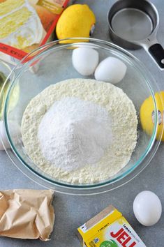 ingredients to make lemon muffins laid out on a counter top, including eggs and flour