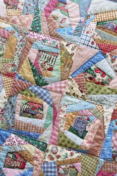 a close up of a quilt with many different designs