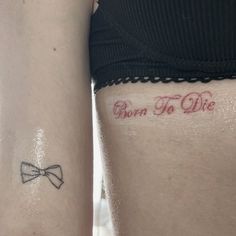 two women with tattoos that say born to die and bow ties on their thighs,