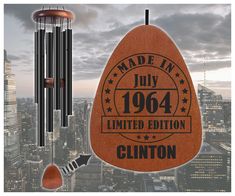 a wind chime hanging from the side of a building with an advertisement on it