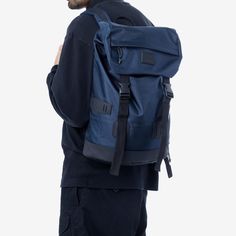 a man wearing a blue backpack and black pants