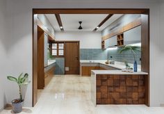 an open kitchen and dining room with wood accents