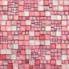 a red and white tile wall with square tiles on it's sides, all in shades of pink