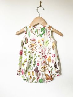 Your little will look super cool while staying cool in this bubble romper! So perfect for layering in cooler weather, and on it's own for hot summer days! This is sewn up in our beautiful flora & fauna print. This stylish bodysuit features cotton produced in the USA that is certified organic by global organic textile standards so you can feel good about dressing your baby in it! We serge all seams for added durability and strength. We include snaps for easy dressing and diapering. Here is ou Cute Printed Jumpsuits And Rompers For Playwear, Cotton Floral Print Bubble Romper For Playwear, Casual Printed Bubble Romper For Play, Fun Sleeveless Bubble Romper For Playtime, Playful Floral Bubble Romper For Playwear, Playful Floral Print Bubble Romper For Playwear, Cute Printed Bubble Romper For Playwear, White Floral Print Bubble Romper For Playtime, Playful Cotton Onesie With Floral Print