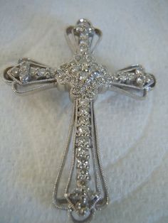 Vintage Stunning 18k Multi Diamonds Cross Pendant Religious Necklace Brooch Pin. Beautiful rich sparkle to stones in 18k White Gold. So brilliant, yet soft sparkle. Large Statement Beauty. The cross is marked 750. Total diamond weight is .84 cts. The clarity of the diamonds if G-I and the clarity if SI2-I1. The cross appraises at $2,175.00 Free Ship In the USA. Email for Quote to ship out of USA. Thank you for viewing. Diamond White Brooch For Formal Occasions, Diamond White Brooch For Formal Wear, Formal Diamond White Brooch Jewelry, Formal Diamond White Jewelry With Brooch, Fine Jewelry Diamond White Brooch, Diamond Brooch Jewelry For Formal Occasions, Formal Diamond Brooch Jewelry, Anniversary Fine Jewelry Brooch, Diamond Round Brooch Jewelry