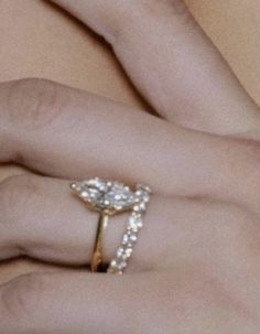 a woman's hand with a ring on it and a diamond in the middle