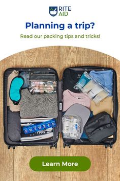 an open suitcase filled with clothes and other items on top of a wooden floor next to a sign that says, planning a trip? read our packing tips and tricks