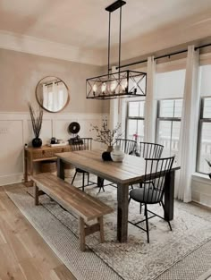 a dining room table with chairs and a bench