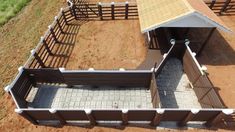 an aerial view of a horse barn with stalls