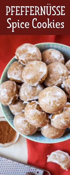 a bowl filled with donuts sitting on top of a red table cloth next to spices